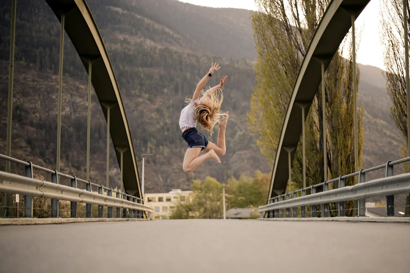 Two dancers in a low, weighted lift with off-vertical alignment, illustrative of Jiří Kylián's athletic, floor-connected choreographic style