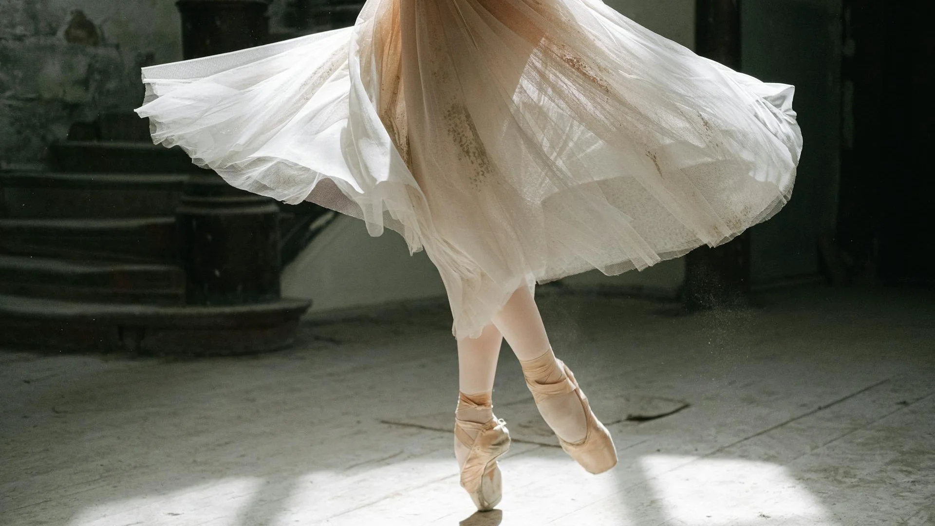 A dancer in a shaft of light, illustrative of a Nederlands Dans Theater premiere