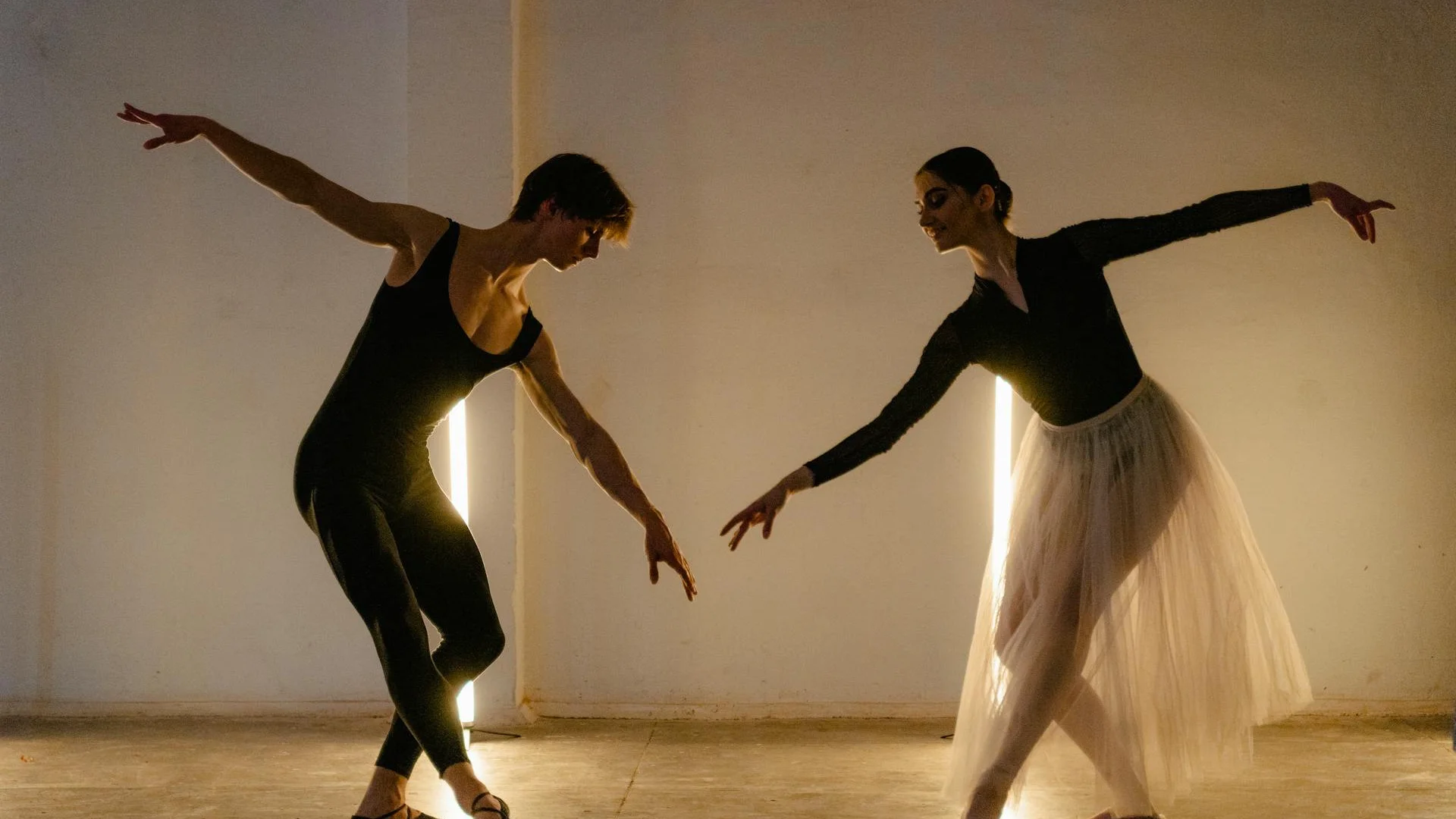 Dancers moving under harsh stage lighting with a raised band platform behind them, illustrative of Political Mother