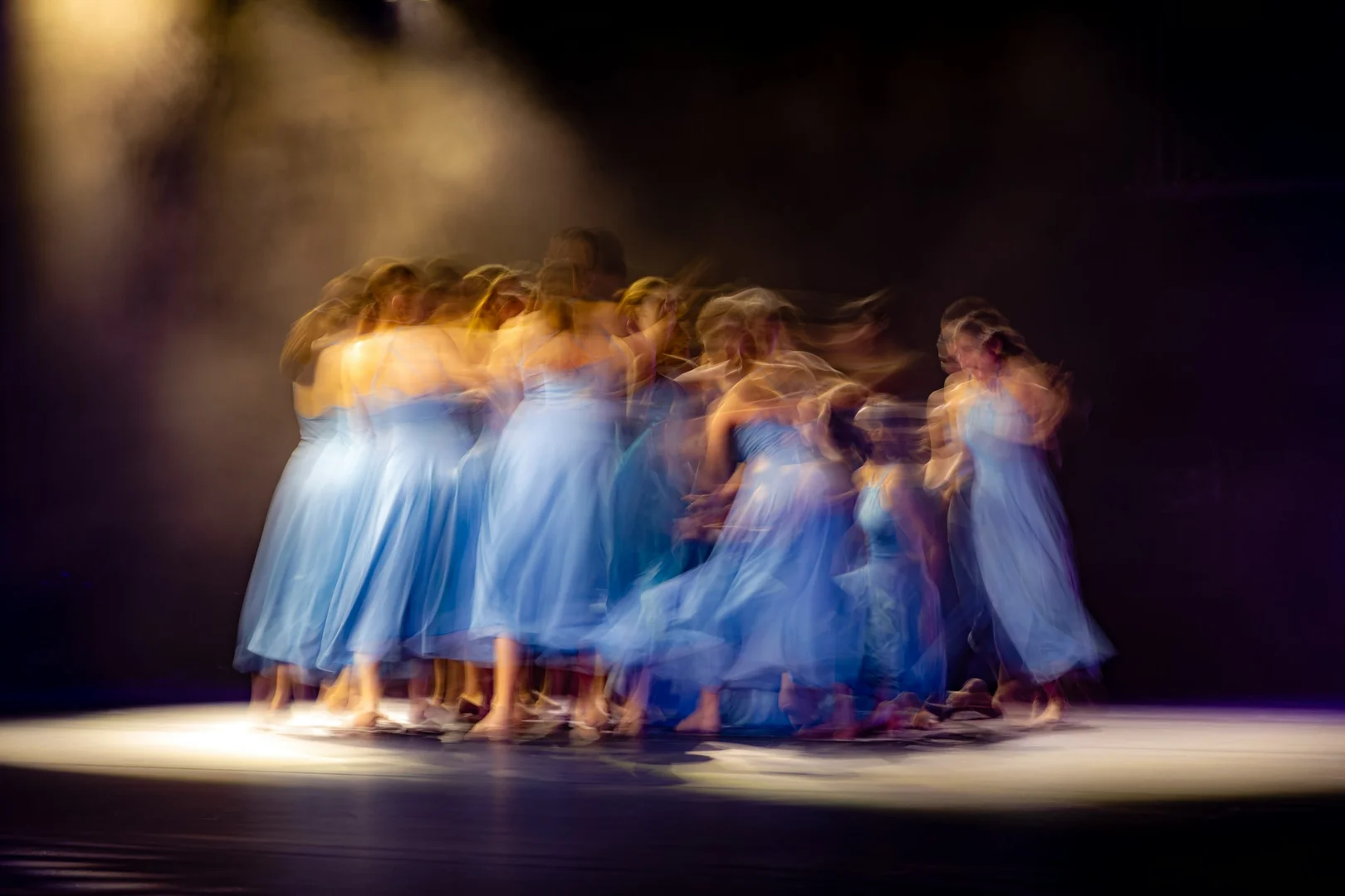 A dancer in a low, off-center lunge with loose, athletic energy, illustrative of Twyla Tharp's crossover choreographic style